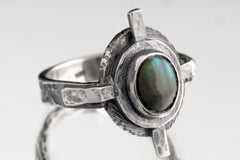 Rainbow Labradorite Compass Ring shown on white background with layered silver detail and old-world artifact shape.