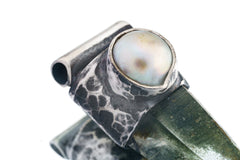 Close-up of old South Sea Pearl set above Nepal Inclusion Quartz in an oxidized sterling silver Stack Pendant cap.