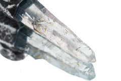 Close-up of Nepal Inclusion Quartz showing green mineral inclusions, natural crystal structure, and pointed termination.