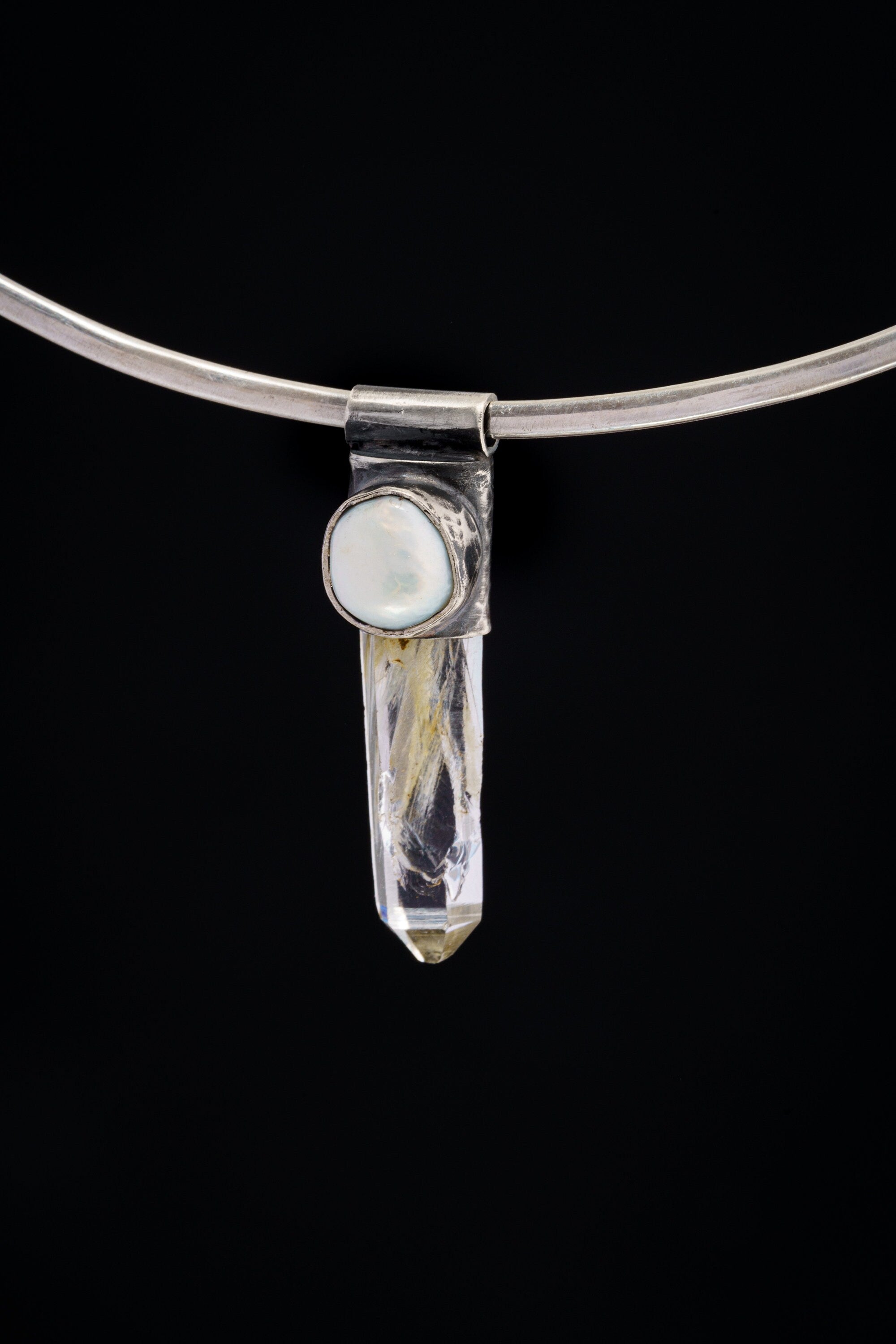 Nepal Inclusion Quartz South Sea Pearl Stack Pendant shown on black background with oxidized sterling silver cap and clear crystal body.
