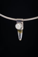 Nepal Quartz and South Sea Pearl Stack Pendant shown on black background with silver choker and pointed crystal body.