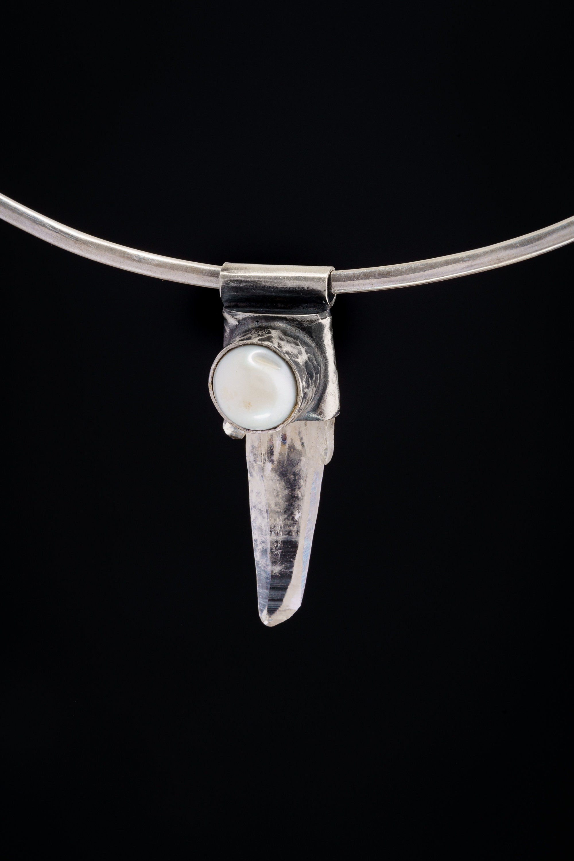 Nepal Clear Quartz and South Sea Pearl Stack Pendant shown on black background with silver choker and clear crystal body.