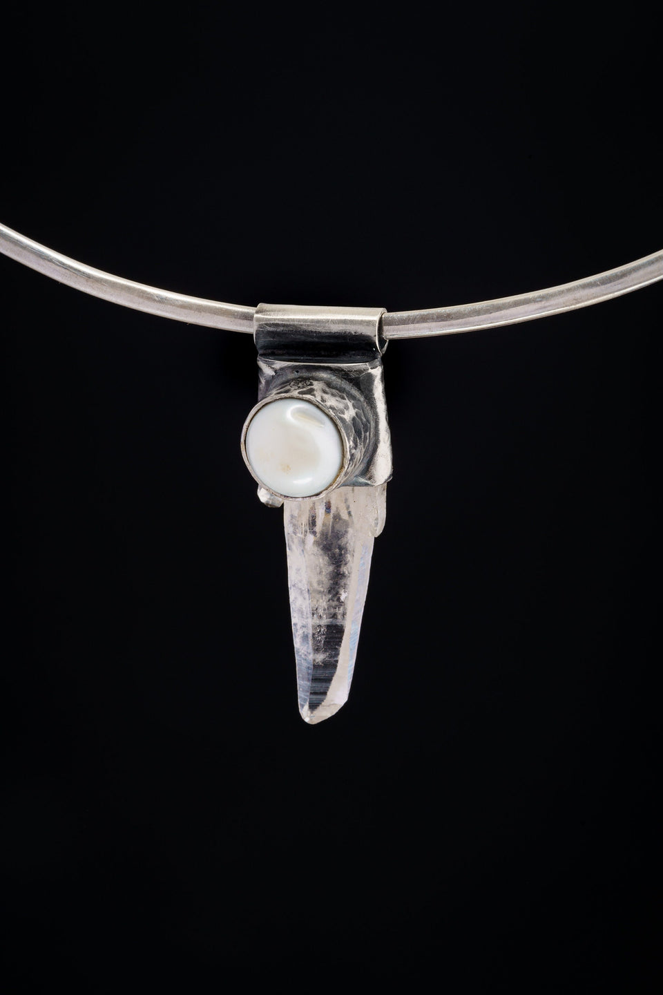 Nepal Clear Quartz and South Sea Pearl Stack Pendant shown on black background with silver choker and clear crystal body.