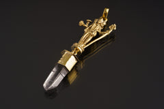 Lord Shiva Clear Quartz pendant shown on a dark background with warm brass setting and clear crystal point.