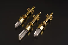 Standing Ganesha Clear Quartz talisman pendant shown on a dark background with polished brass figure and Himalayan Quartz crystal.