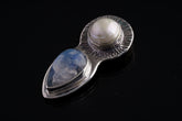 Blue Moonstone Pearl Venus pendant shown on dark background with handmade sterling silver goddess design.