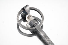 Close-up of raw Aquamarine ritual spoon showing hammered oxidized silver texture and pale blue-green crystal.