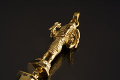 Close-up of brass Standing Lord Ganesha figure holding a trident above Himalayan Clear Quartz.