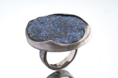 Side view of XXL Lapis Lazuli statement ring showing thick sterling silver setting and large round blue stone.