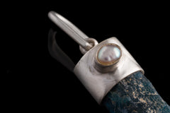 Close-up of South Sea Pearl accent and large hinged bail on a Blue Apatite wand pendant in brushed sterling silver.