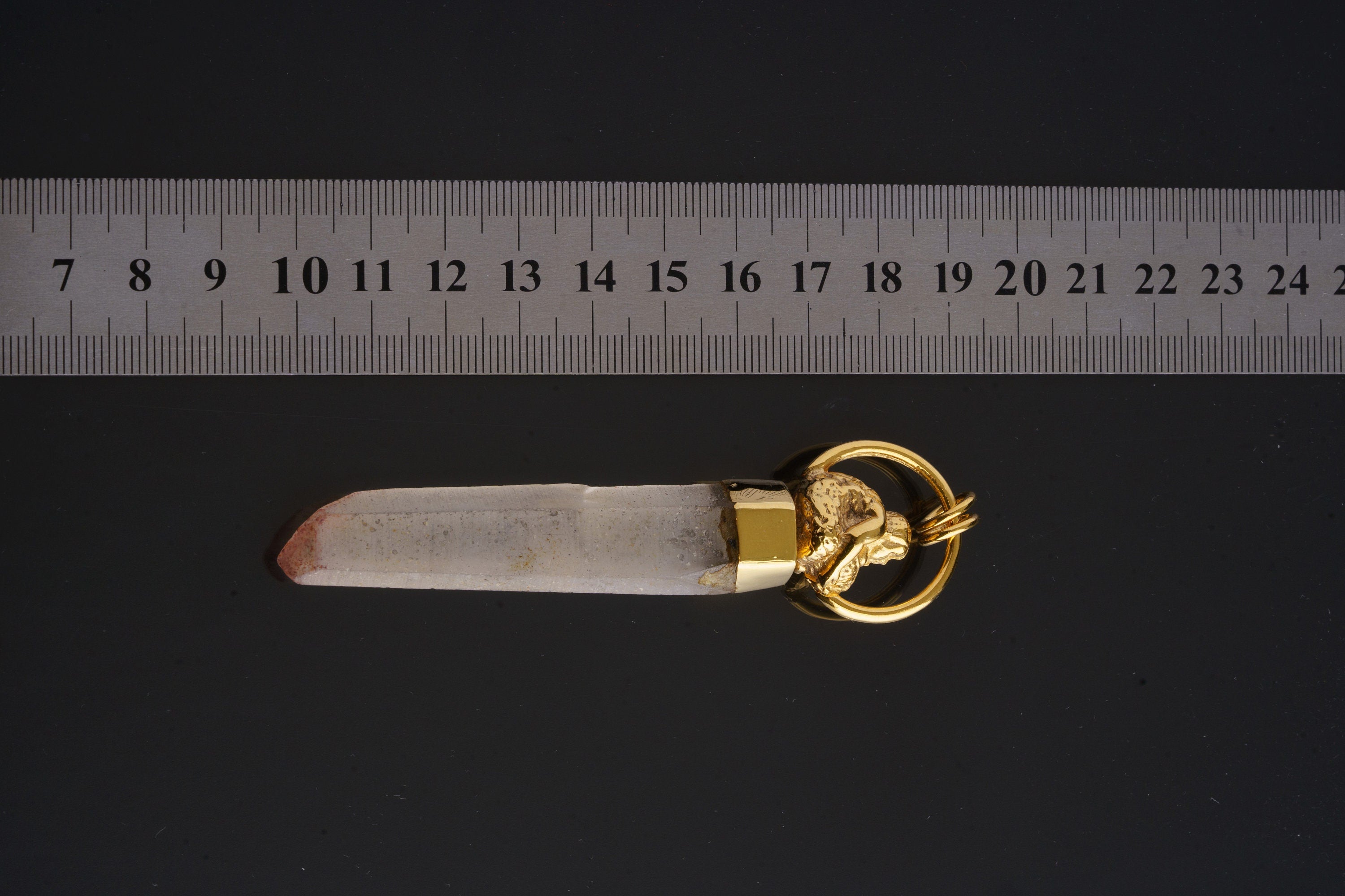 Golden Buddha Quartz talisman pendant shown beside a ruler for scale with Clear Quartz and gold-plated setting.