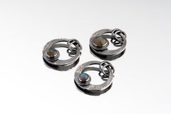 Three Rainbow Labradorite crescent moon pendants in oxidized 925 sterling silver, shown with hammered texture and circular flash stones.