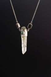 Verdant Quartz Relic Necklace shown on black background with Raw Quartz Point, Emerald, Garnet accents, and sterling silver chain.