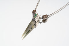 Himalayan Quartz Emerald Dravite Tourmaline pendant shown on light background with raw Australian Emerald and side Tourmalines.