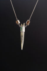 Himalayan Quartz Emerald Dravite Tourmaline pendant shown on black background with long clear Quartz point and oxidized silver chain.