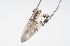 Himalayan Vision Pendant shown on light background with Red Kyanite, Dravite Tourmalines, and clear Himalayan Quartz point.