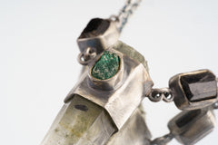 Close-up of Verdant Quartz Relic Necklace showing green Emerald set in sterling silver over a raw Quartz Point.