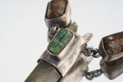 Close-up of raw Australian Emerald and Dravite Tourmaline set into an oxidized sterling silver Himalayan Quartz pendant.