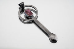Pink Tourmaline sterling silver brushed spoon pendant shown on white background with soft pink stone and sculptural silver form.