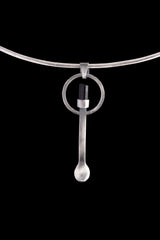 Black Tourmaline silver spoon pendant displayed on a choker, showing wearable talisman styling and spoon form.