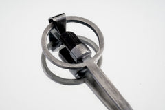 Close-up of Black Tourmaline spoon pendant showing hammer-textured sterling silver and protective dark stone.