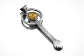 Mexican Amber sterling silver fairy spoon shown on white background with brushed silver and warm golden resin setting.