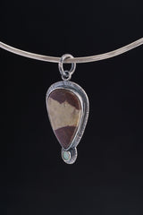 Mookaite Opal pendant displayed on a choker against black background with handmade sterling silver setting.