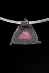 Rhodochrosite pendant shown from the back with open-back sterling silver triangle construction.