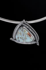 Larimar triangle pendant displayed on a choker against black background with concealed tubular bail.