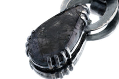 Raw teardrop Moonstone held in brutalist oxidized sterling silver claw setting.