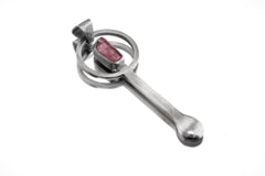 Rubellite Tourmaline sterling silver brushed spoon pendant shown on white background with red-pink stone and sculptural silver form.