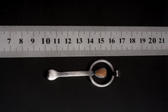 Ethiopian Opal ritual spoon pendant shown beside a ruler for scale with polished sterling silver body.