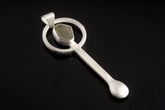 Himalayan Aquamarine sterling silver spoon pendant shown on dark background with brushed silver and stone setting.