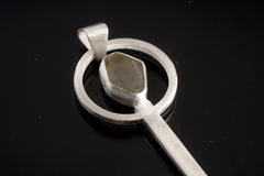 Aquamarine spoon pendant shown close-up with solid 925 sterling silver cast form and circular stone setting.