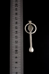 Himalayan Aquamarine spoon pendant shown beside a ruler for scale, with hand-brushed sterling silver body.