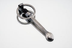Close-up of Black Tourmaline spoon pendant showing hammer-textured sterling silver and protective dark stone.