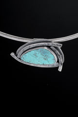 Australian Chrysocolla pendant displayed on a choker with concealed tubular bail and handmade sterling silver setting.
