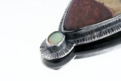 Close-up of Mookaite Ethiopian Opal pendant showing opal accent and textured sterling silver sun-ray detail.