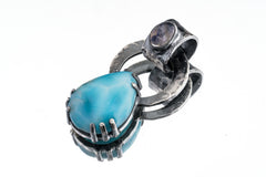 Blue Moonstone Larimar pendant on white background showing teardrop Moonstone, Larimar bail accent, and brutalist silver claws.