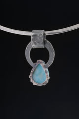 Larimar and Blue Moonstone pendant shown with silver chain, highlighting handmade oxidized silver and blue gemstone contrast.