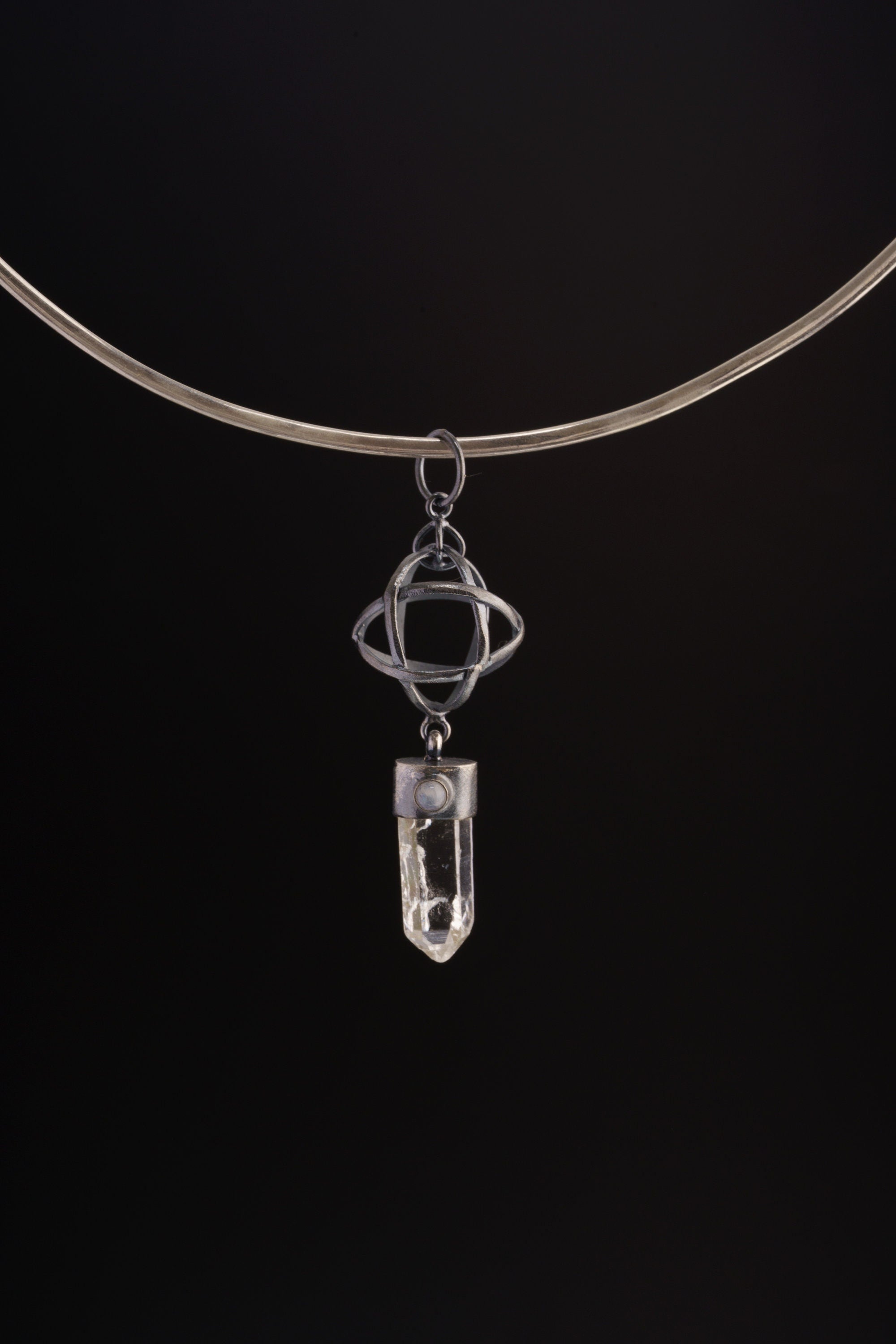 Himalayan Lemurian Quartz Blue Moonstone sphere pendant shown on black cord, with oxidized sterling silver wire sphere.