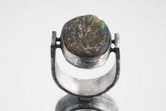 Front view of circular Labradorite ring showing U-shaped oxidized silver band and sculptural oculus setting.