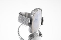 Side view of Moonstone ring showing bark-like oxidized silver texture, coiled supports, and raised rectangular stone.