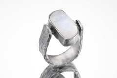 Lunar Sanctuary Moonstone ring in oxidized 925 sterling silver with rectangular glowing stone and bark-like texture.