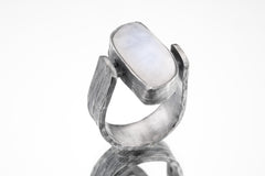 Lunar Sanctuary Moonstone ring in oxidized 925 sterling silver with rectangular glowing stone and bark-like texture.