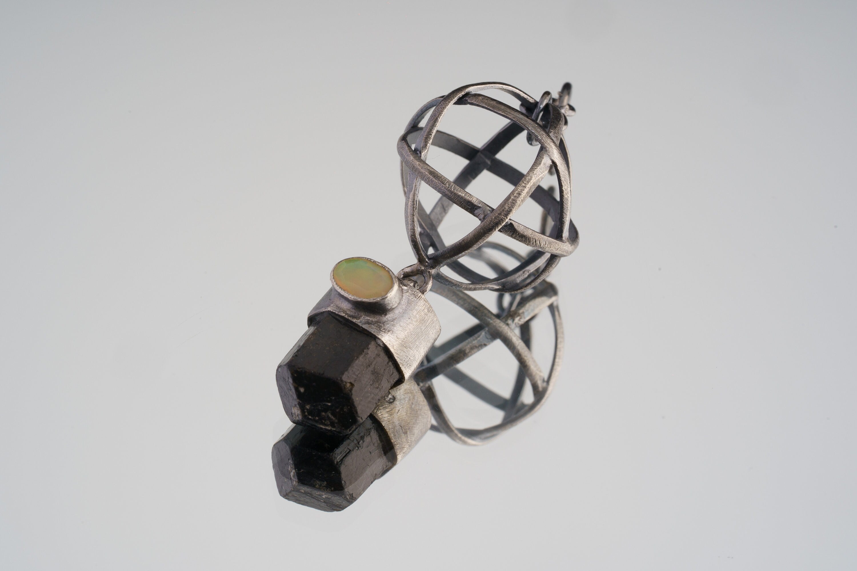 Himalayan Brown Tourmaline and Ethiopian Opal sphere pendant in oxidized 925 sterling silver, shown with Brutalist wire construction.