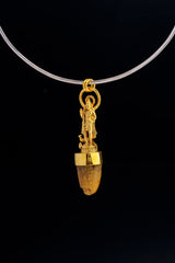 Shiva cow horn pendant displayed on black background with 24k gold-plated finish and spiritual talisman design.