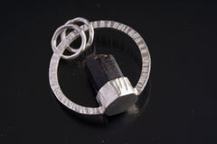 Close view of hammered silver halo pendant with Himalayan Tourmaline crystal.