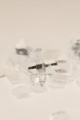 Raw Himalayan Aquamarine ring displayed on clear quartz, with oxidized sterling silver band and handmade wrap setting.
