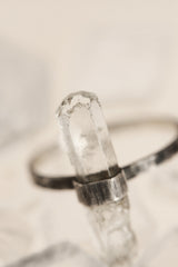 Close-up of raw Aquamarine crystal ring showing icy blue clarity, natural crystal structure, and oxidized silver wrap setting.